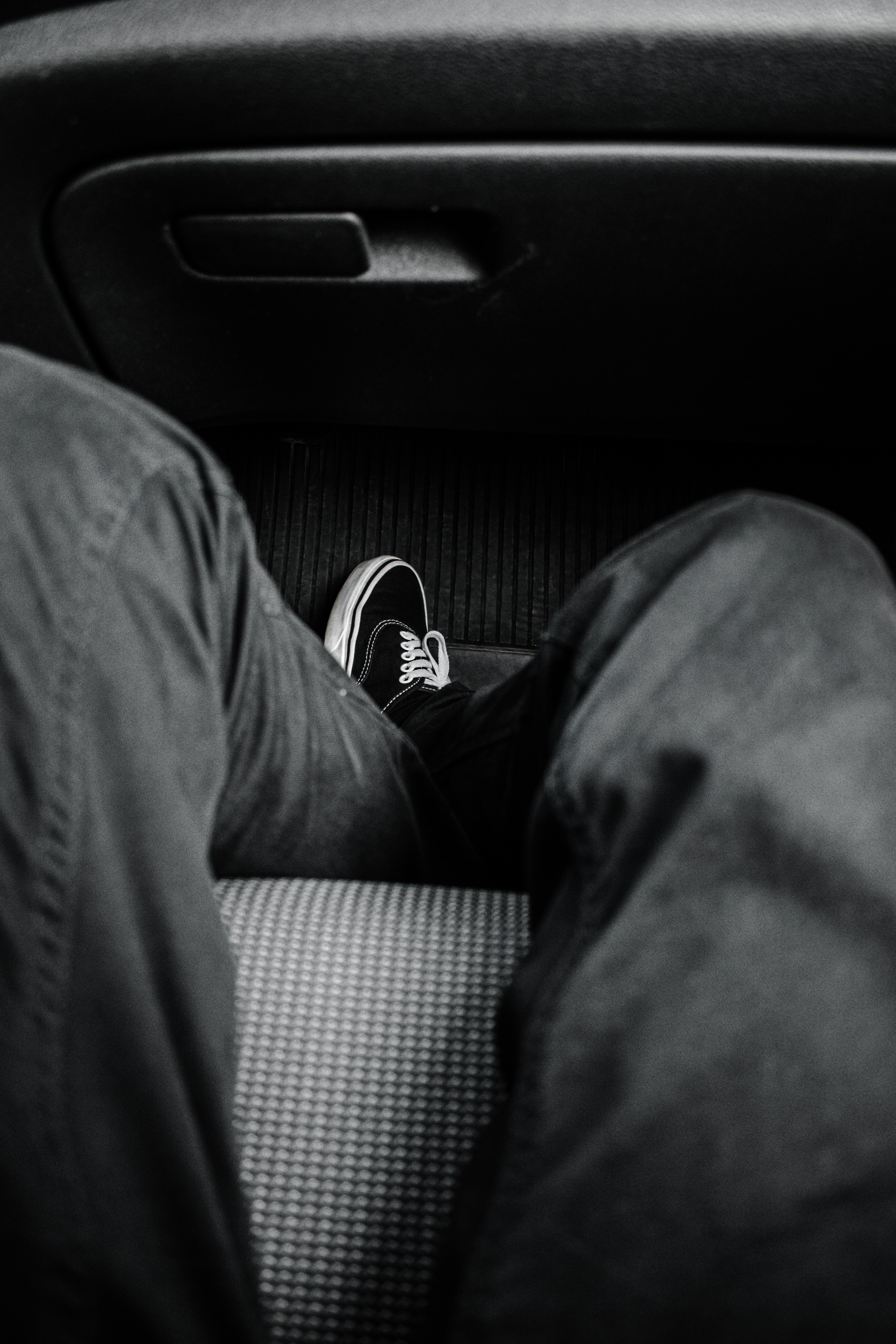 person in black pants and black and white sneakers